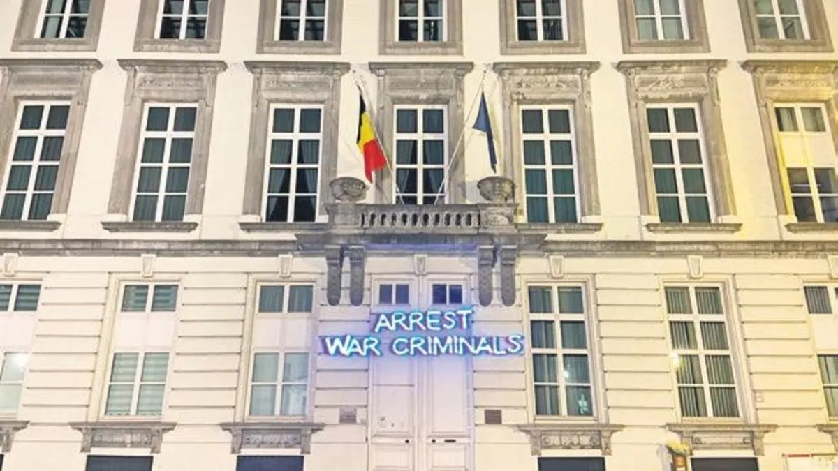 Belçika hükümetine tepki: Savaş suçlusunu tutuklayın